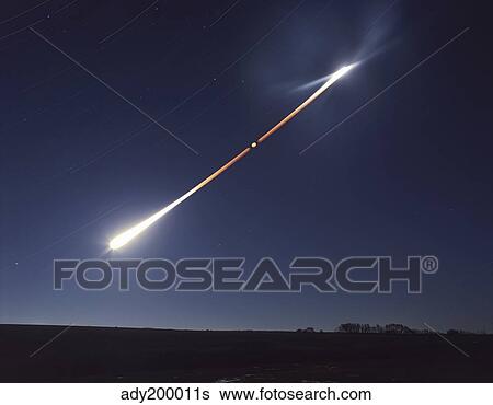 Stock Photograph - Total lunar eclipse with eclipse motion trail.. Fotosearch