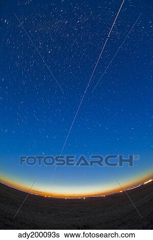 Trail of the International Space Station coming out of the western twilight. View Large Photo Image Stock Photograph - Trail of the International Space Station coming out of the western twilight.. Fotosearch