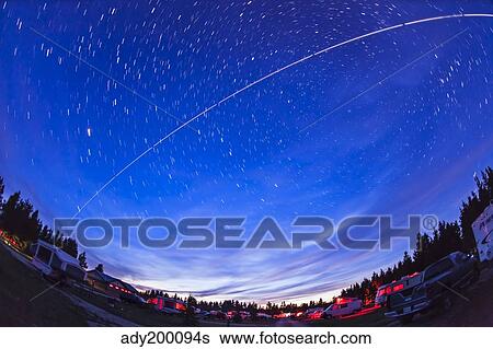Trail of the International Space Station as it passes over a campground in Canada. View Large Photo Image Stock Photograph - Trail of the International Space Station as it passes over a campground in Canada.. Fotosearch