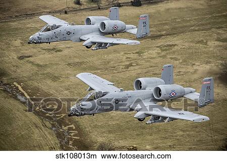 Two A-10 Thunderbolt II's conduct a training mission over Arkansas. View Large Photo Image Picture - Two A-10 Thunderbolt II's conduct a training mission over Arkansas.. Fotosearch