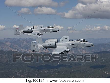 Two A-10 Thunderbolt's fly over the mountains in Central Idaho. View Large Photo Image Picture - Two A-10 Thunderbolt's fly over the mountains in Central Idaho.. Fotosearch