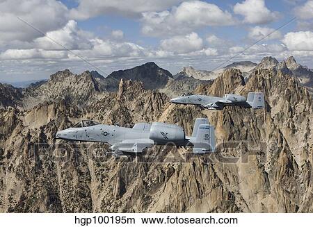 Two A-10 Thunderbolt's fly over the mountains in Central Idaho. View Large Photo Image Picture - Two A-10 Thunderbolt's fly over the mountains in Central Idaho.. Fotosearch
