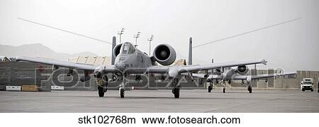 Two A-10 Thunderbolts taxi out to the runway. View Large Photo Image Picture - Two A-10 Thunderbolts taxi out to the runway.. Fotosearch