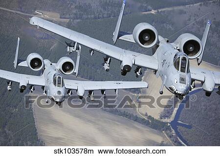 Two A-10C Thunderbolt II aircraft fly in formation. View Large Photo Image Picture - Two A-10C Thunderbolt II aircraft fly in formation.. Fotosearch