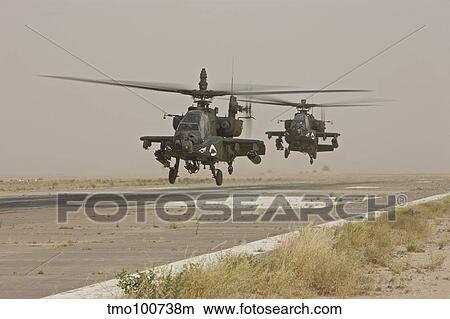Two AH-64 Apache helicopters prepare to land on on the runway. View Large Photo Image Picture - Two AH-64 Apache helicopters prepare to land on on the runway.. Fotosearch