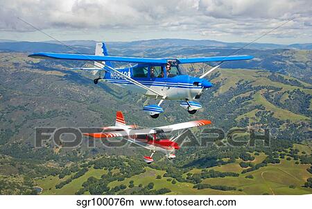 Two Champion Aircraft Citabrias in flight. View Large Photo Image Picture - Two Champion Aircraft Citabrias in flight.. Fotosearch