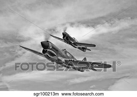 Two Curtiss P-40 Warhawks in flight near Nampa, Idaho. View Large Photo Image Picture - Two Curtiss P-40 Warhawks in flight near Nampa, Idaho.. Fotosearch