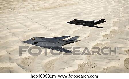 Two F-117 Nighthawk stealth fighters fly over White Sands National Monument. View Large Photo Image Picture - Two F-117 Nighthawk stealth fighters fly over White Sands National Monument.. Fotosearch