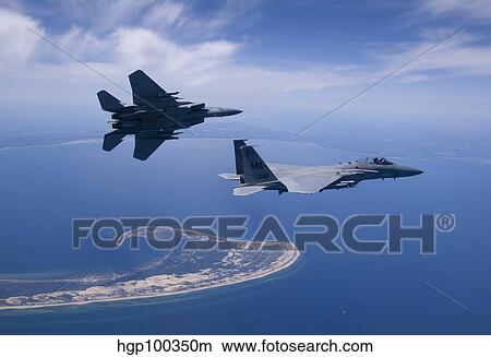 Two F-15 Eagles fly high over Cape Cod, Massachusetts. View Large Photo Image Picture - Two F-15 Eagles fly high over Cape Cod, Massachusetts.. Fotosearch