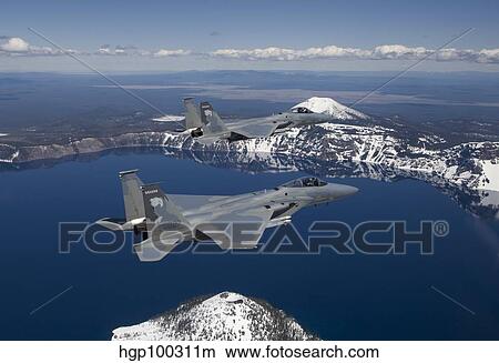 Two F-15 Eagles fly over Crater Lake in Central Oregon. View Large Photo Image Picture - Two F-15 Eagles fly over Crater Lake in Central Oregon.. Fotosearch