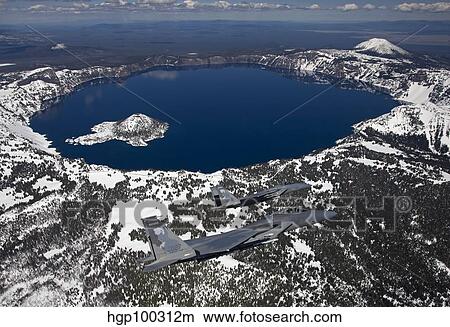Two F-15 Eagles fly over Crater Lake in Central Oregon. View Large Photo Image Picture - Two F-15 Eagles fly over Crater Lake in Central Oregon.. Fotosearch