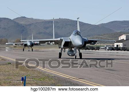 Two F-15 Eagles taxi out to take off on a training mission. View Large Photo Image Picture - Two F-15 Eagles taxi out to take off on a training mission.. Fotosearch