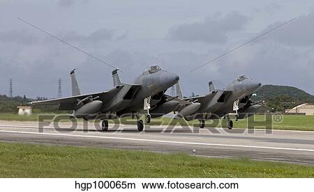 Two F-15's come in for a landing at Kadena Air Base, Okinawa, Japan. View Large Photo Image Picture - Two F-15's come in for a landing at Kadena Air Base, Okinawa, Japan.. Fotosearch