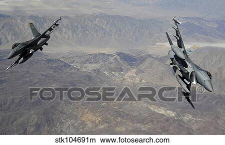 Two F-16 Fighting Falcons break out of formation. View Large Photo Image Picture - Two F-16 Fighting Falcons break out of formation.. Fotosearch