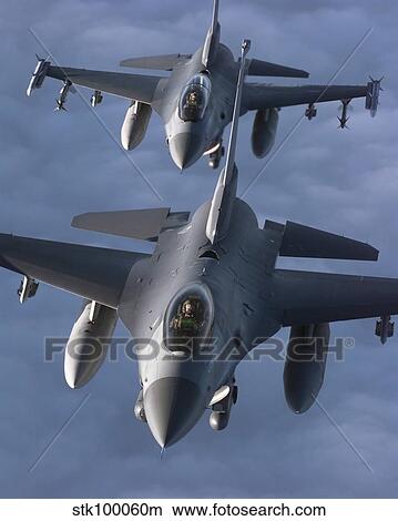 Two F-16 Fighting Falcons fly in formation. View Large Photo Image Picture - Two F-16 Fighting Falcons fly in formation.. Fotosearch