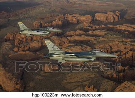 Two F-16's fly in formation over Northern Arizona. View Large Photo Image Picture - Two F-16's fly in formation over Northern Arizona.. Fotosearch