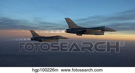 Two F-16's fly in formation over Arizona before sunset. View Large Photo Image Picture - Two F-16's fly in formation over Arizona before sunset.. Fotosearch