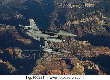 Two F-16's fly in formation over the Grand Canyon, Arizona. View Large Photo Image Picture - Two F-16's fly in formation over the Grand Canyon, Arizona.. Fotosearch
