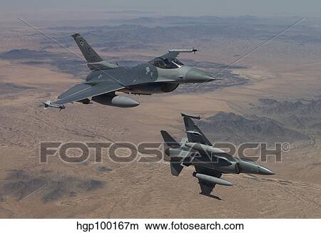 Two F-16's on a training mission over the Arizona desert. View Large Photo Image Picture - Two F-16's on a training mission over the Arizona desert.. Fotosearch