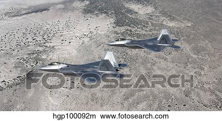 Two F-22 Raptors fly a training mission over New Mexico. View Large Photo Image Picture - Two F-22 Raptors fly a training mission over New Mexico.. Fotosearch