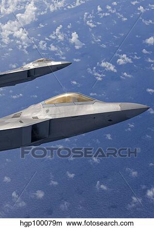 Two F-22 Raptors fly in formaton over Japan. View Large Photo Image Picture - Two F-22 Raptors fly in formaton over Japan.. Fotosearch