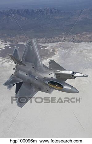 Two F-22 Raptors maneuver while on a training mission over New Mexico. View Large Photo Image Picture - Two F-22 Raptors maneuver while on a training mission over New Mexico.. Fotosearch