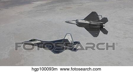 Two F-22 Raptors on a training mission over New Mexico. View Large Photo Image Picture - Two F-22 Raptors on a training mission over New Mexico.. Fotosearch