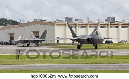 Two F-22 Raptor's taxi to the end of runway at Kadena Air Base, Japan. View Large Photo Image Picture - Two F-22 Raptor's taxi to the end of runway at Kadena Air Base, Japan.. Fotosearch