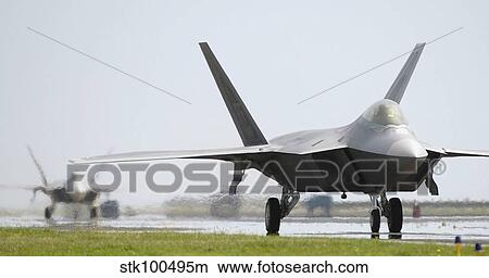 Two F-22A Raptors taxi down the runway. View Large Photo Image Picture - Two F-22A Raptors taxi down the runway.. Fotosearch