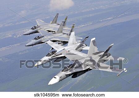 Two F/A-18 Hornets and two F-15 Strike Eagles fly in an echelon formation. View Large Photo Image Picture - Two F/A-18 Hornets and two F-15 Strike Eagles fly in an echelon formation.. Fotosearch