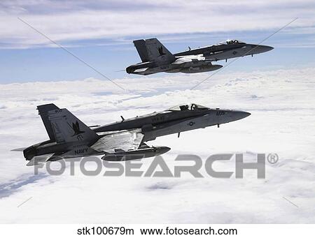 Two F/A-18C Hornets fly over the Pacific Missile Range Facility. View Large Photo Image Picture - Two F/A-18C Hornets fly over the Pacific Missile Range Facility.. Fotosearch