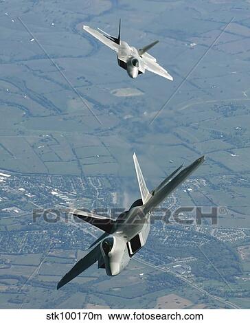 Two F/A-22 Raptor aircraft prepare for refueling. View Large Photo Image Picture - Two F/A-22 Raptor aircraft prepare for refueling.. Fotosearch