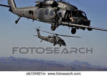 Two HH-60 Pave Hawk helicopters prepare for aerial refueling. View Large Photo Image Picture - Two HH-60 Pave Hawk helicopters prepare for aerial refueling.. Fotosearch