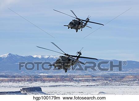 Picture - Two HH-60G Pave Hawk's fly in formation over New Mexico.. Fotosearch