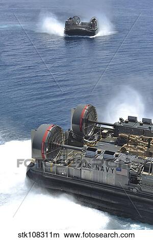 Two landing craft air cushions depart the well deck of USS Bataan. View Large Photo Image Picture - Two landing craft air cushions depart the well deck of USS Bataan.. Fotosearch