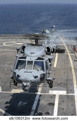 Two MH-60S Sea Hawk helicopters take off from USS Ponce. View Large Photo Image Picture - Two MH-60S Sea Hawk helicopters take off from USS Ponce.. Fotosearch