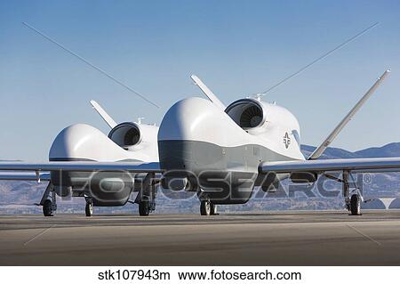 Picture - Two MQ-4C Triton unmanned aerial vehicles on the tarmac.. Fotosearch