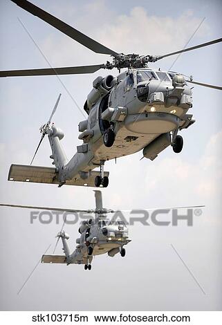 Two multi-mission MH-60R Sea Hawk helicopters fly in tandem. View Large Photo Image Picture - Two multi-mission MH-60R Sea Hawk helicopters fly in tandem.. Fotosearch