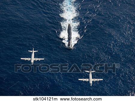 Two P-3 Orion maritime surveillance aircraft fly over attack submarine USS Houston. View Large Photo Image Picture - Two P-3 Orion maritime surveillance aircraft fly over attack submarine USS Houston.. Fotosearch