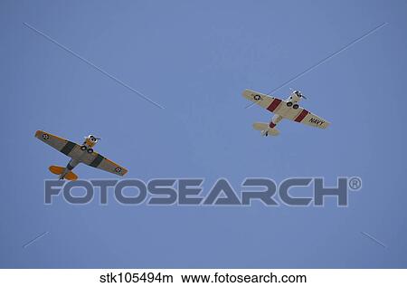 Two restored vintage warbirds in flight near Lakeland, Florida. View Large Photo Image Picture - Two restored vintage warbirds in flight near Lakeland, Florida.. Fotosearch