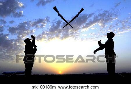 Picture - Two Staff Sergeants perform the Overs maneuver while practicing drill for the Base Honor Guard.. Fotosearch