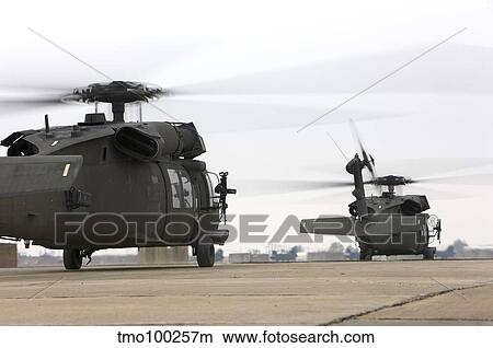 Two UH-60 Black Hawks taxi out for a mission over northern Iraq. View Large Photo Image Picture - Two UH-60 Black Hawks taxi out for a mission over northern Iraq.. Fotosearch