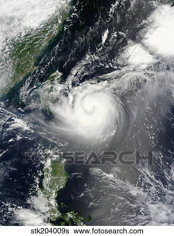 Stock Photograph - Typhoon Tembin hovers over the western Pacific Ocean.. Fotosearch