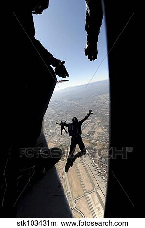 Picture - U. S. Air Force Academy Parachute Team jumps out of an aircraft over Nellis Air Force Base, Nevada. Fotosearch