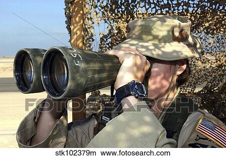 U. S. Air Force Airman looks through a set of binoculars. View Large Photo Image Picture - U. S. Air Force Airman looks through a set of binoculars.. Fotosearch