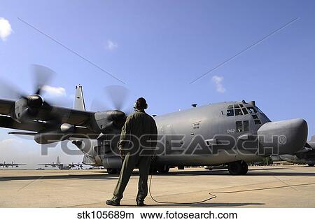 U. S. Air Force Airman observes an MC-130H Combat Talon II. View Large Photo Image Picture - U. S. Air Force Airman observes an MC-130H Combat Talon II.. Fotosearch