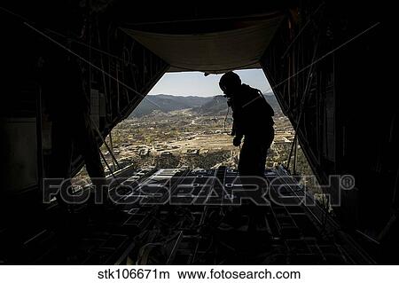 U. S. Air Force Airman pushes out pallets from a C-130H Hercules. View Large Photo Image Picture - U. S. Air Force Airman pushes out pallets from a C-130H Hercules.. Fotosearch
