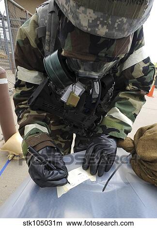 U. S. Air Force Airman writes on M8 chemical detection paper during an operational readiness exercise. View Large Photo Image Picture - U. S. Air Force Airman writes on M8 chemical detection paper during an operational readiness exercise.. Fotosearch