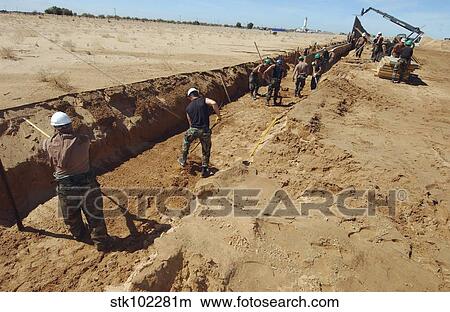 U. S. Air Force Airmen dig a trench. View Large Photo Image Picture - U. S. Air Force Airmen dig a trench.. Fotosearch