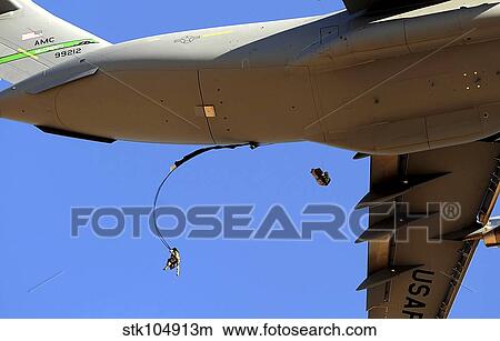 U. S Air Force Airmen parachute into a drop zone from a C-17 Globemaster III. View Large Photo Image Picture - U. S Air Force Airmen parachute into a drop zone from a C-17 Globemaster III.. Fotosearch